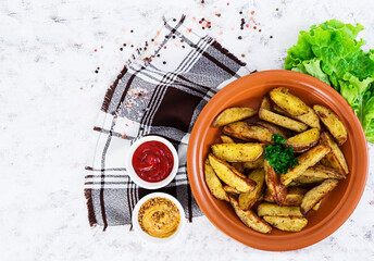 Baked potato wedges with spices. Top view