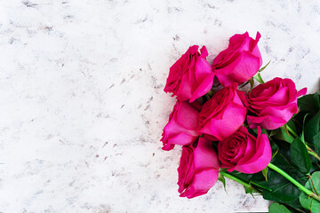 Bouquet of pink roses on dark background. Top view