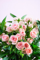 Bouquet of several branches of pink roses. Background of pink roses