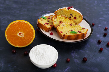 Cupcake with orange and cranberries on dark purple background