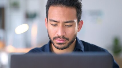 Focused, concentrating and thinking business man reading information on a laptop and working on a task at work. Young male entrepreneur sending an email, typing a reply and trying to meet a deadline - Powered by Adobe