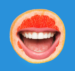 Funny ripe grapefruit with pink lips on blue background
