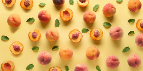 Many ripe peaches on yellow background. Pattern for design