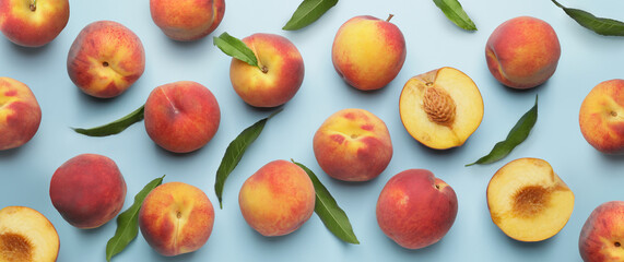 Many ripe peaches on light blue background. Pattern for design