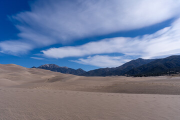 Fototapeta na wymiar Sand dunes with Rocky mountains