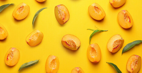 Many cut ripe peaches on yellow background. Pattern for design