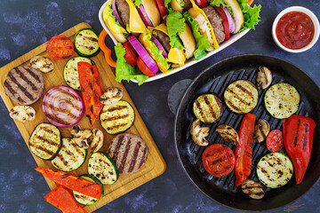 Grilled vegetables and handmade burger. Zucchini, eggplant, mushrooms, pepper on the grill. Top view