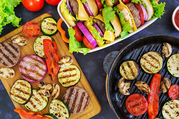 Grilled vegetables and handmade burger. Zucchini, eggplant, mushrooms, pepper on the grill. Top view