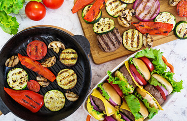 Grilled vegetables and handmade burger. Zucchini, eggplant, mushrooms, pepper on the grill. Top view