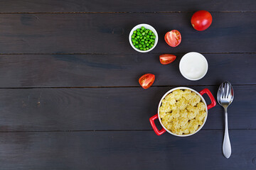 Homemade shepherd's pie on wooden background