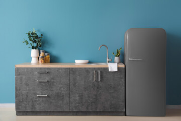 Grey fridge in interior of modern kitchen
