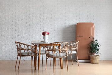 Stylish retro fridge in interior of dining room