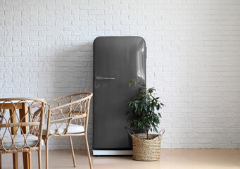 Stylish grey retro fridge in interior of dining room