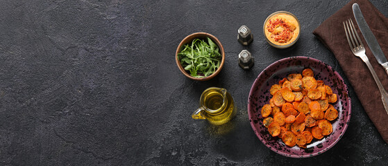 Plate with tasty baked carrots on dark background with space for text