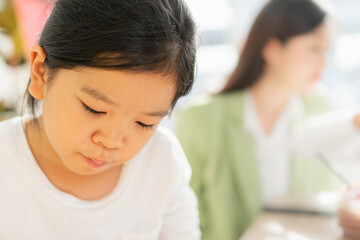 cute little children wear white shirt, look down to intend learn in education classroom. asian beautiful children happy and fun color painting education in small school