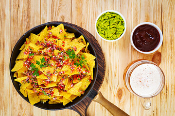 Mexican nachos with cheese. Corn chips with guacamole, salsa and tomato ketchup.