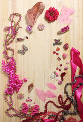 Pink and Magenta Jewelry With Flower on Wooden Table. Top View