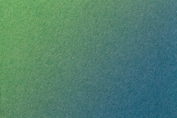 Texture of old green and dark blue paper background, with holographic gradient. Structure of craft olive cardboard