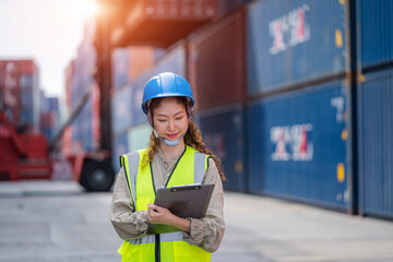 Container yard worker checking container at container yard warehouse,Logistics transportation and shipping business concepts.