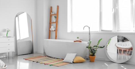 Interior of light bathroom with mirrors