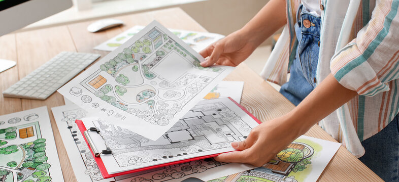 Young female landscape designer working in office, closeup