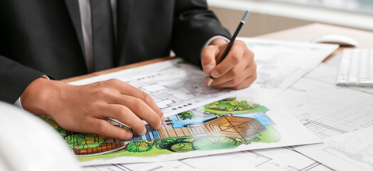 Young male landscape designer working in office, closeup