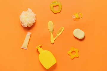 Clock made of bath accessories for baby on color background