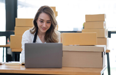 Portrait of Starting small businesses SME owners female entrepreneurs working on receipt box and check online orders to prepare to pack the boxes, sell to customers, sme business ideas online.