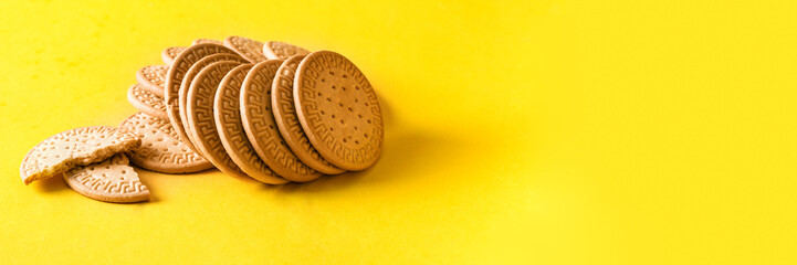 Marie biscuits cookies on bright yellow background for banner.Copy space - obrazy, fototapety, plakaty