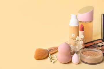 Set of makeup accessories and cosmetics on color background