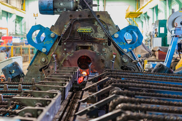 Machine for induction heating of metal. A metal rod heated in an induction furnace. Hot metal...