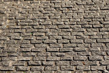 Road or foot path stone surface. Abstract texture for design. Rough stone surface. Traditional construction material