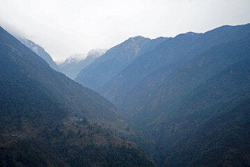 Fototapeta premium Natural landscape of snowy and rocky mountain range with cloudy sky