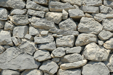 Ancient brick wall in Provence, France. Good for background, banner etc. Stones are irregular, different size and with different light grey tones. .