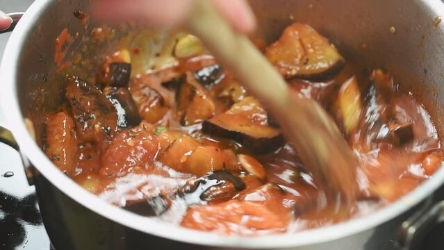 Preparing sauce for pasta alla norma.
