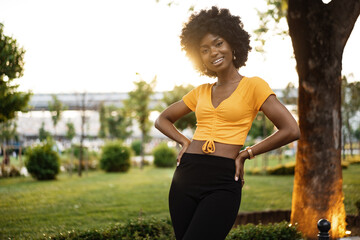 Portrait of a young african american woman smiling standing at the city.