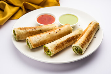 Indian paneer bread roll made using spiced grated cottage cheese mixed with spices & rolled & baked