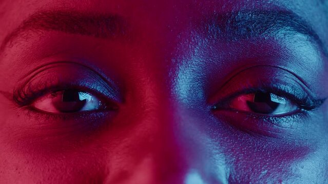 Native African American woman eyes, half-face portrait in neon light. Female person, pretty latin model sight.