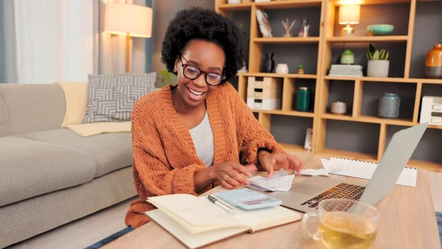 Happy, excited woman paying bills, budgeting and saving or investing her money. Confident female finding success in financial planning, dancing in celebration and writing in her notebook