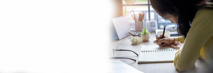 Planner plan Schedule Calendar and reminder agenda, work online at home. Woman hand planning daily appointment and write business trip in diary book at office desk-panoramic banner for web header.