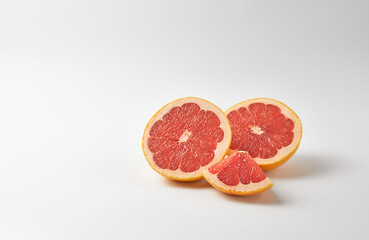 Grapefruit halves on white background. The concept is a healthy dessert.