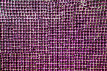 Close up of pink ceramic tiles on historical wall