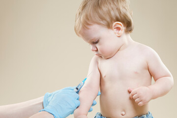 Medical Ideas and Concepts. One Little Caucasian Boy Is Beeing Vaccinated with Protective Vaccine