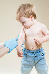 Medical Concepts. One Little Caucasian Boy Is Beeing Vaccinated with Protective Vaccine.