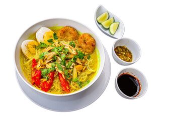 INDONESIAN CULINARY CHICKEN SOUP NOODLE WITH SLICE BOILING EGG AND FRIED MASHED POTATOS AS TOPPING