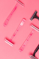 Shaving Concepts. Flat-Lay Image of Various Women's Colorful Pink and Black  Disposable Razors Shavers Placed in Different Directions On Pink Coral Background.