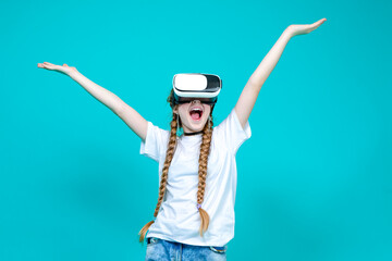 Happy and Excited Caucasian Teenager Female in White Shirt Posing in Modern Virtual Reality VR Helmet with Lifted hands Exclaiming