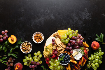 Autumn cheese board with fresh fruits and berries served with white wine, top view