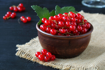 Red currants in a clay bowl.