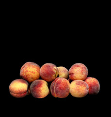 harvest of ripe peaches on black background